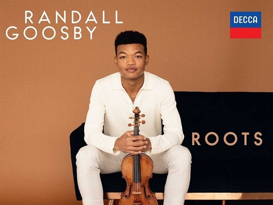 Randall Goosby Roots cd cover. A man sits on a couch holding his violin.